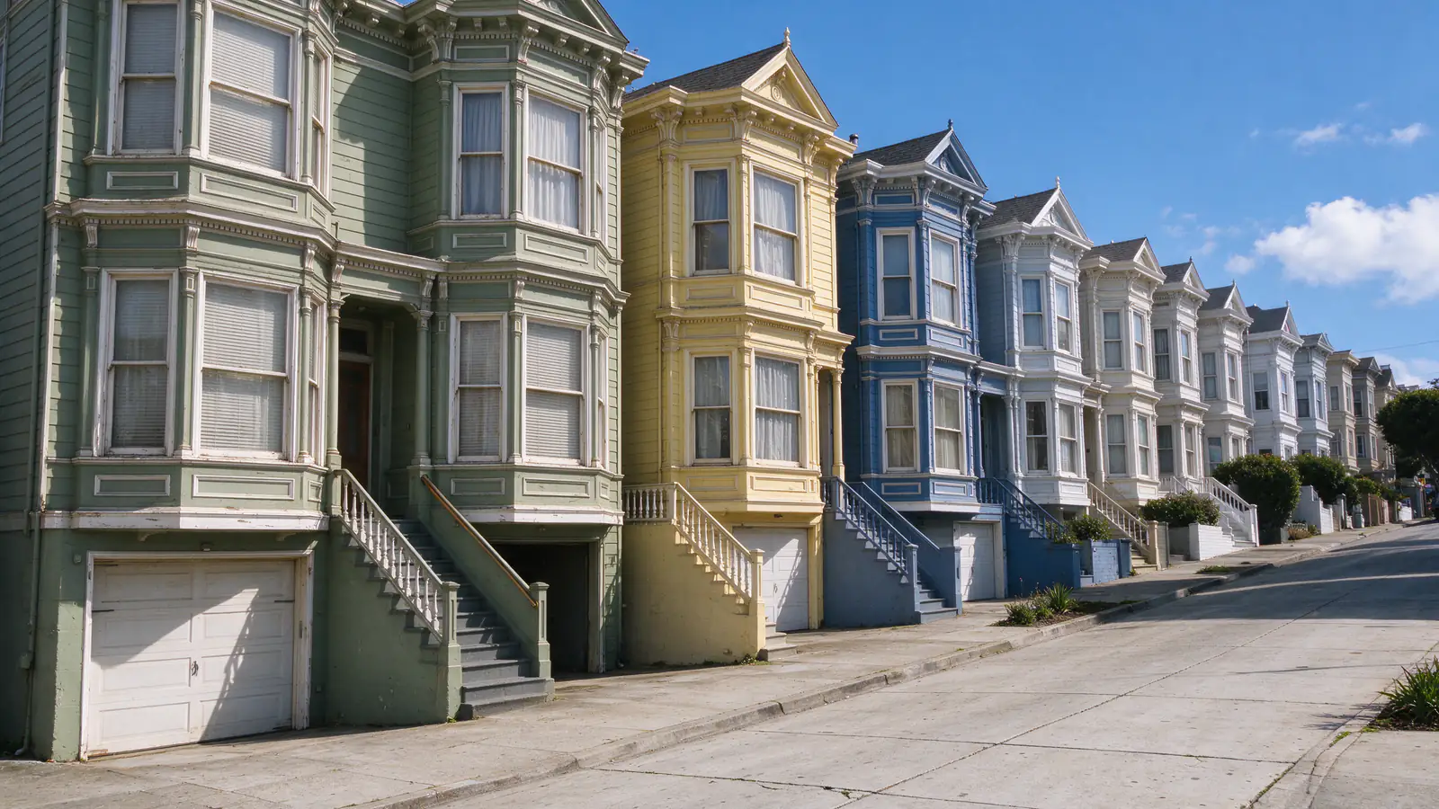 A sunny sloping San Francisco block of attached Victorian and Edwardian houses with bay windows, rooflines stepping down the hill